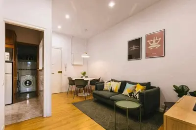 a living room with a couch and a table at Cozy & Central Apartment in Barcelona
