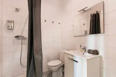 a bathroom with a toilet and a sink and a shower at Cozy & Central Apartment in Barcelona