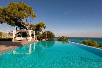 a swimming pool with a view of the ocean at Villa Brisa del Mar Seafront villa located in the Garraf National Park 30 minutes from Barcelona in Sant Pere de Ribes