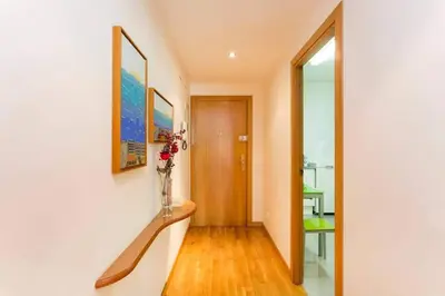 a hallway with a staircase with a vase of flowers at Fabulous Flat By Paseo De Gracia in Barcelona