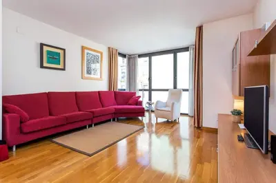 a living room with a red couch and a tv at Fabulous Flat By Paseo De Gracia in Barcelona