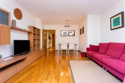 a living room with a red couch and a tv at Fabulous Flat By Paseo De Gracia in Barcelona