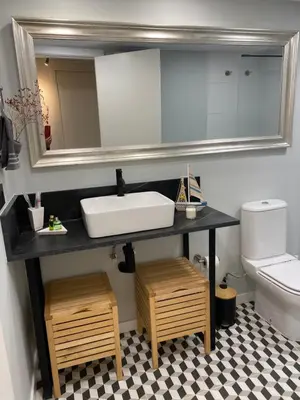 a bathroom with a sink and a mirror and a toilet at Vive la playa y la noche de Sitges aquí in Sitges