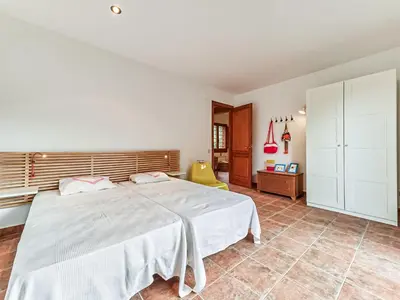 a bedroom with a large white bed in a room at Holiday Home Montseny with Pool in Montseny