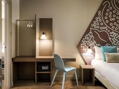 a bedroom with a large white bed and a window at ibis Styles Barcelona Centre in Barcelona