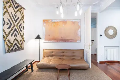 a living room with a couch and a table at Modernist apartment in the best location, Eixample in Barcelona