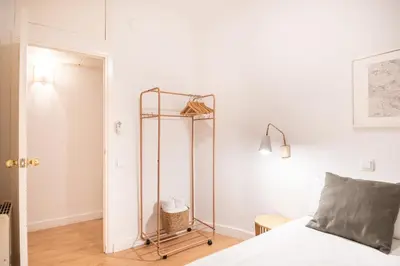 a white bedroom with a bed and a glass closet at Comfortable Apartment for Groups next to Sagrada Familia, Barcelona in Barcelona