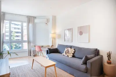a living room with a blue couch and a table at Comfortable Apartment for Groups next to Sagrada Familia, Barcelona in Barcelona