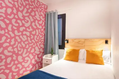 a bedroom with a bed with a red wall at Spacious & Comfortable Apartment in Barcelona City Center in Barcelona