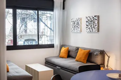 a living room with a couch and a window at Spacious & Comfortable Apartment in Barcelona City Center in Barcelona
