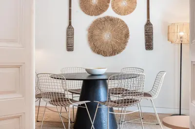 a dining room with a black table and chairs at Sunny Central Apartment with 100sqm Terrace in Barcelona in Barcelona