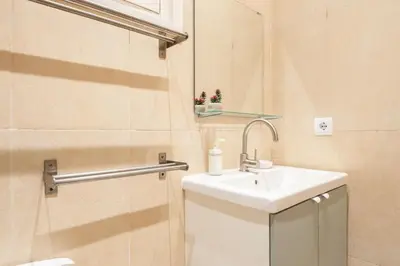 a small bathroom with a sink and a shower at Sunny Central Apartment with 100sqm Terrace in Barcelona in Barcelona