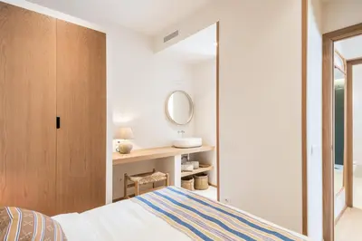 a bedroom with a bed and a mirror at Mediterranean Retreat with 4-Bedroom, 3-Bath Apartment in Barcelona in Barcelona