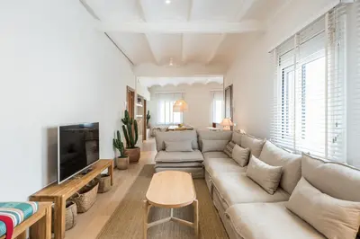 a living room with a couch and a tv at Mediterranean Retreat with 4-Bedroom, 3-Bath Apartment in Barcelona in Barcelona