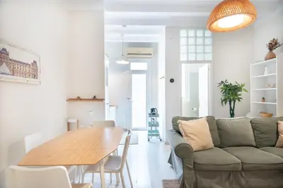 a living room with a couch and a table at Cozy Apartment in the Heart of Gracia, Barcelona in Barcelona