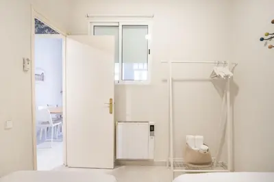 a white room with a shower and a glass door at Cozy Apartment in the Heart of Gracia, Barcelona in Barcelona