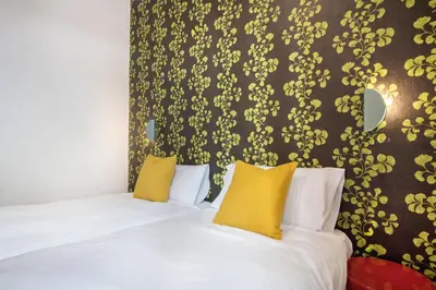 a bedroom with a bed with yellow pillows at Oasis with a terrace in the heart of Gracia, Barcelona in Barcelona