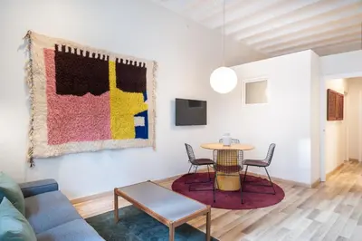 a living room with a table and chairs and a couch at Oasis with a terrace in the heart of Gracia, Barcelona in Barcelona