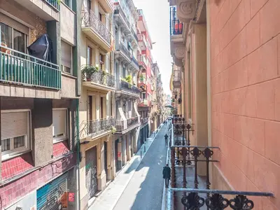 an empty street in an alley between buildings at Sunny Apartment with Private Terrace in Gracia, Barcelona in Barcelona