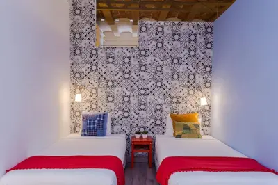 two beds in a small room with a wall at Charming 3 Bdr-2 Bthr In Gracia in Barcelona