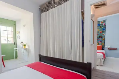 a bedroom with a bed with a red blanket at Charming 3 Bdr-2 Bthr In Gracia in Barcelona