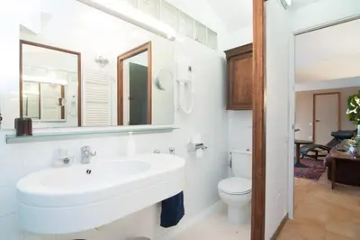 a white bathroom with a sink and a toilet at Magic Place in Barcelona