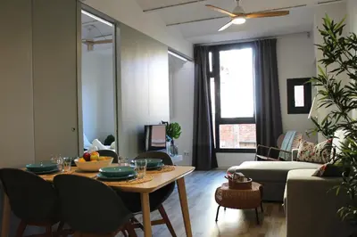 a living room with a table and a couch at Piso nuevo al lado de la Sagrada Familia. in Barcelona
