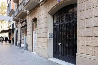 a building with black doors on the side of a street at Piso nuevo al lado de la Sagrada Familia. in Barcelona