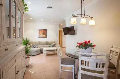 a kitchen and living room with a table and a couch at BCNGOTIC 11 in Barcelona