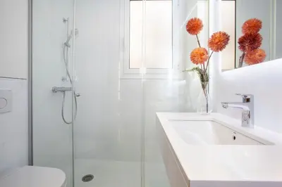 a white bathroom with a sink and a shower at BCNGOTIC 41 in Barcelona