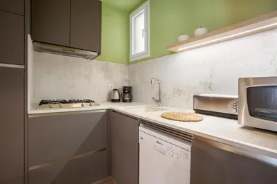 a kitchen with a sink and a microwave at BCNGOTIC 41 in Barcelona