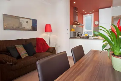 a living room with a couch and a dining room table at BCNGOTIC 33 in Barcelona