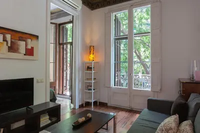 a living room with a couch and a tv at AB Casanova Apartment in Barcelona