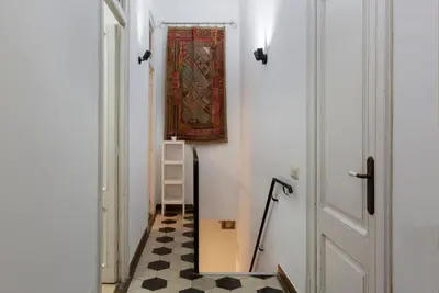 a hallway with a rug on the wall and a door at AB Casanova Apartment in Barcelona