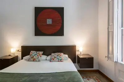 a bedroom with a bed with two night stands and two lamps at AB Casanova Apartment in Barcelona