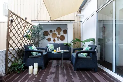 a patio with two chairs and a table on a deck at AB Rossello Center Terrace in Barcelona
