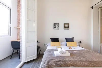 a bedroom with a bed with towels on it at AB Centric Universitat in Barcelona