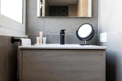 a bathroom with a sink with a mirror on it at AB Centric Universitat in Barcelona