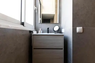 a bathroom with a sink and a mirror at AB Centric Universitat in Barcelona