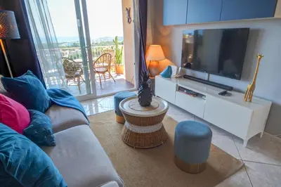 a living room with a couch and a flat screen tv at Palma Fiesta Apartment by Hello Homes Sitges in Sant Pere de Ribes