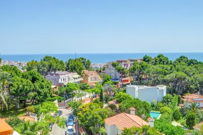 an aerial view of a city with trees and houses at Palma Fiesta Apartment by Hello Homes Sitges in Sant Pere de Ribes