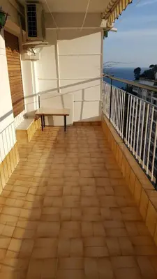 a balcony with a table and a bench on it at Apart 2 habit vistas playa y montaña lift parking in Calella