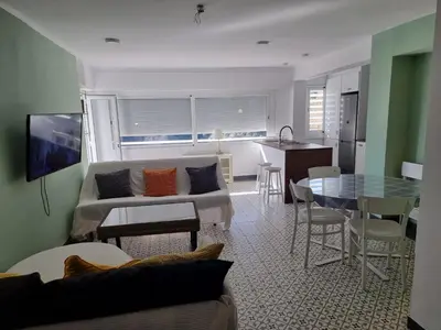 a living room with a couch and a table at Apart 2 habit vistas playa y montaña lift parking in Calella