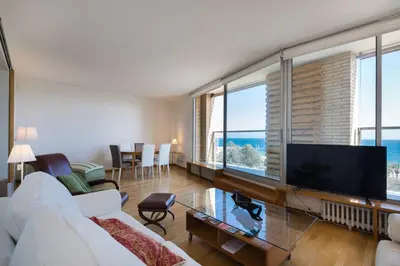 a living room with a white couch and a flat screen tv at Sea views & city skyline in Barcelona