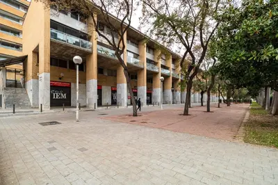 a building with a brick sidewalk in front of a building at Comtal homey apartments in Barcelona