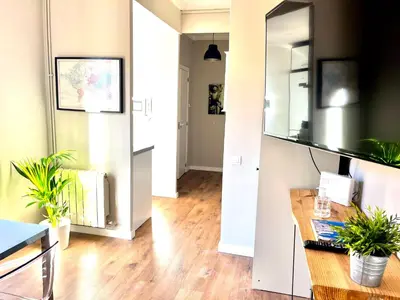 a living room with a table and a mirror at Sunny apartment Gracia - Joanic Renovated in Barcelona