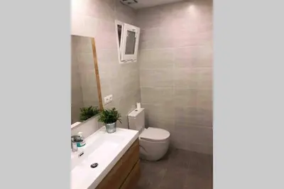 a bathroom with a toilet and a sink at 2 BEDROOM APARTMENT SANTS in Barcelona