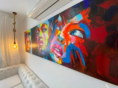 a painting hanging on a wall next to a couch at Besos Beach Gem II By MyRentalHost in Sant Adria de Besos