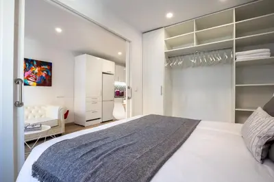 a bedroom with a large white bed and a closet at Besos Beach Gem II By MyRentalHost in Sant Adria de Besos