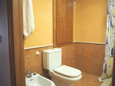 a bathroom with a toilet and a sink at NINFA Apartamento con balcón ideal familias con vistas al mar in Pineda de Mar